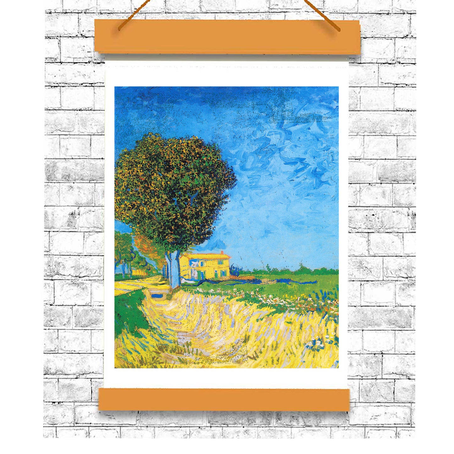 Framed artwork of a landscape with a tree and house on a white brick wall.