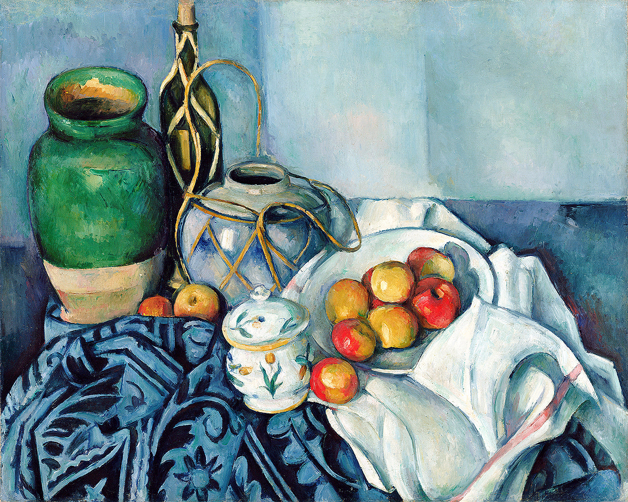 A framed print of a still life painting featuring a green vase, a transparent decanter, apples on a cloth, and a decorative teacup.
