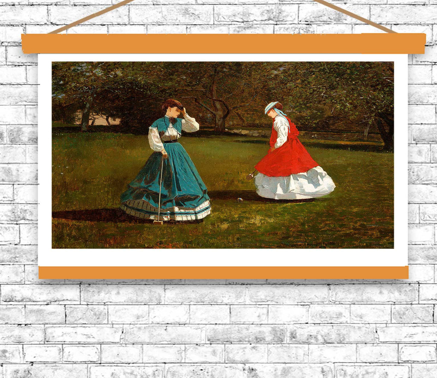 Framed artwork of two women in dresses on a grassy field with a white brick wall background.