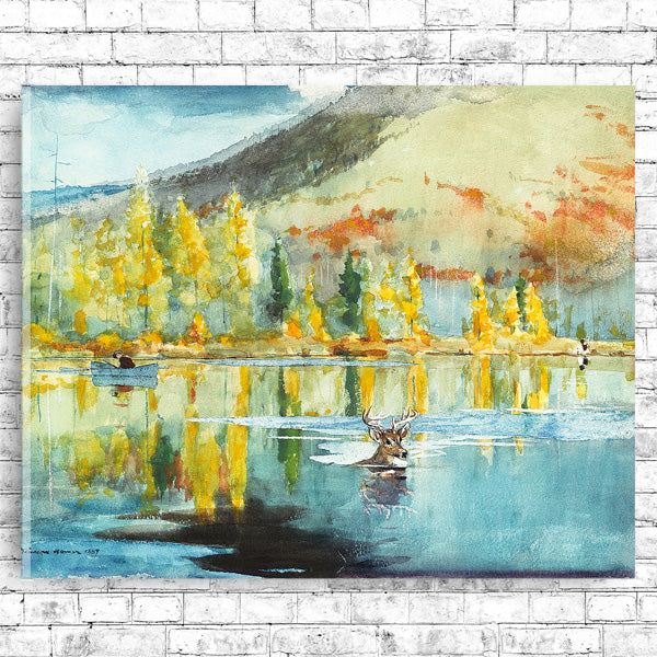 A framed print depicting a landscape with trees and a body of water, reflecting autumn colors.