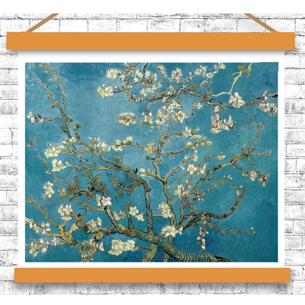 Framed artwork of a floral branch against a blue background on a white brick wall.