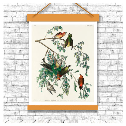 Decorative poster with birds on a branch hanging on a brick wall.