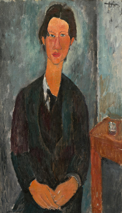 A framed portrait painting of a person wearing a dark jacket, with a simple interior background.