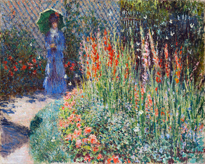 A framed print of a painting depicting a person in a blue dress walking among vibrant flowers with a pathway and a fence in the background.