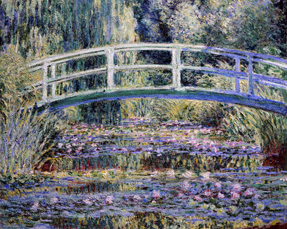 A framed print of 'Water Lilies and Japanese Bridge' by Claude Monet, depicting a scenic view with a bridge over a pond surrounded by greenery.