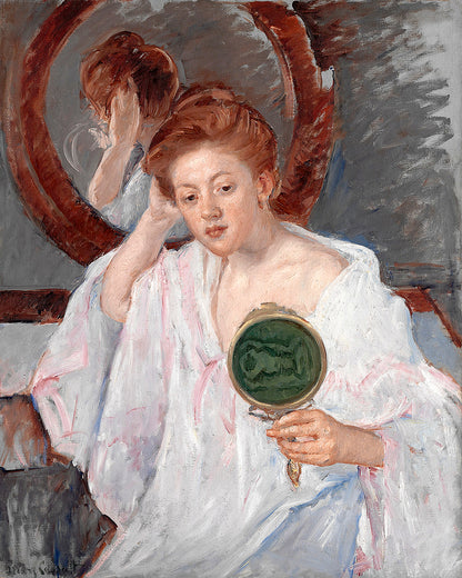 Woman in a white dress holding a hand mirror with a green reflection, sitting in front of a mirror.