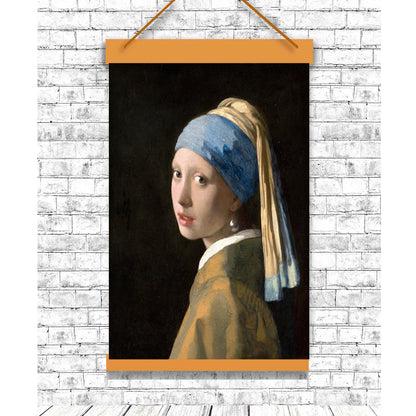 A printed portrait of 'Girl with a Pearl Earring' by Johannes Vermeer, with a focus on the subject wearing a blue headscarf and a pearl earring, framed in a black frame.