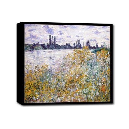 A framed print of a landscape painting featuring a field of flowers with a river and trees in the background, predominantly in yellow and green colors.
