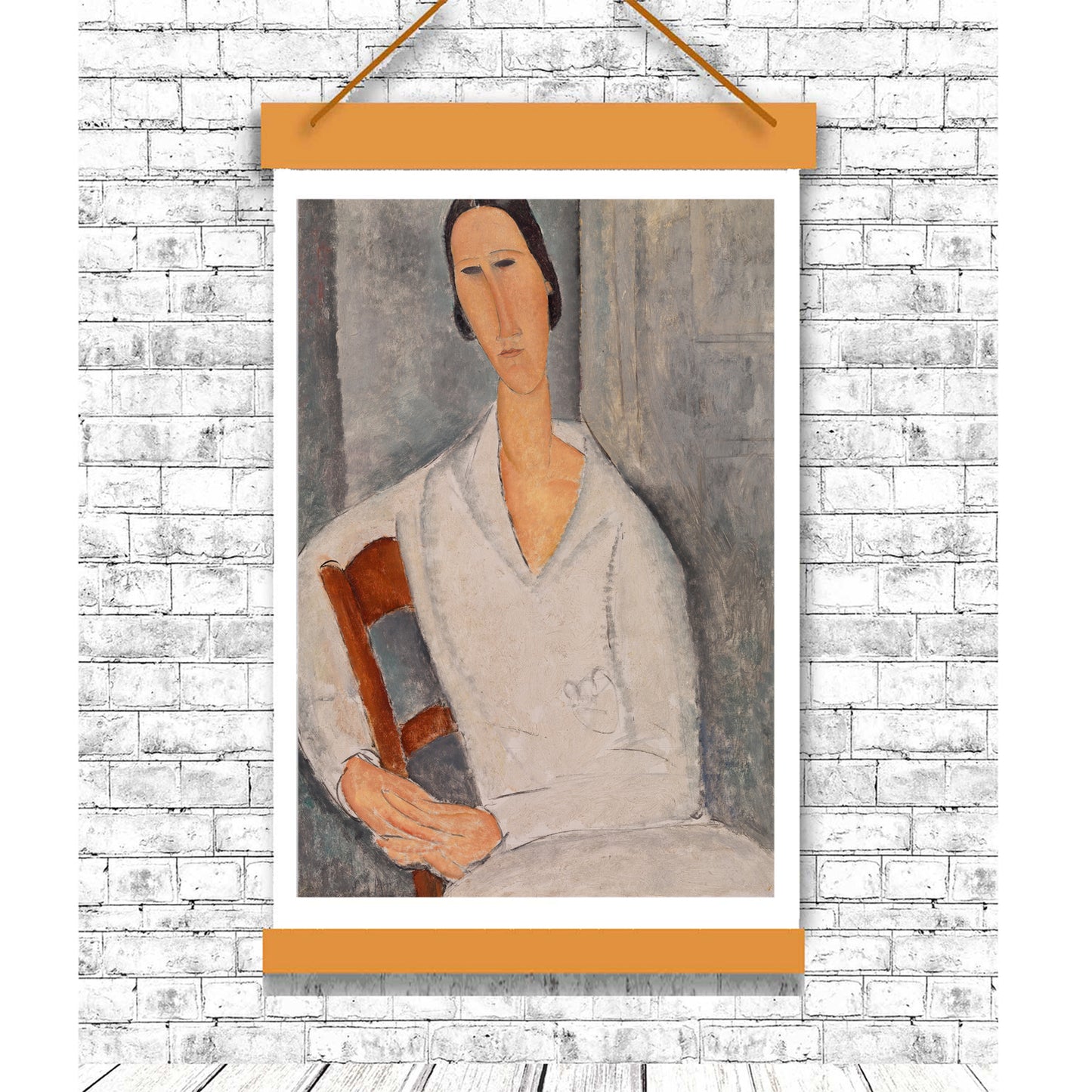 Framed portrait of a woman holding a chair against a white brick wall.