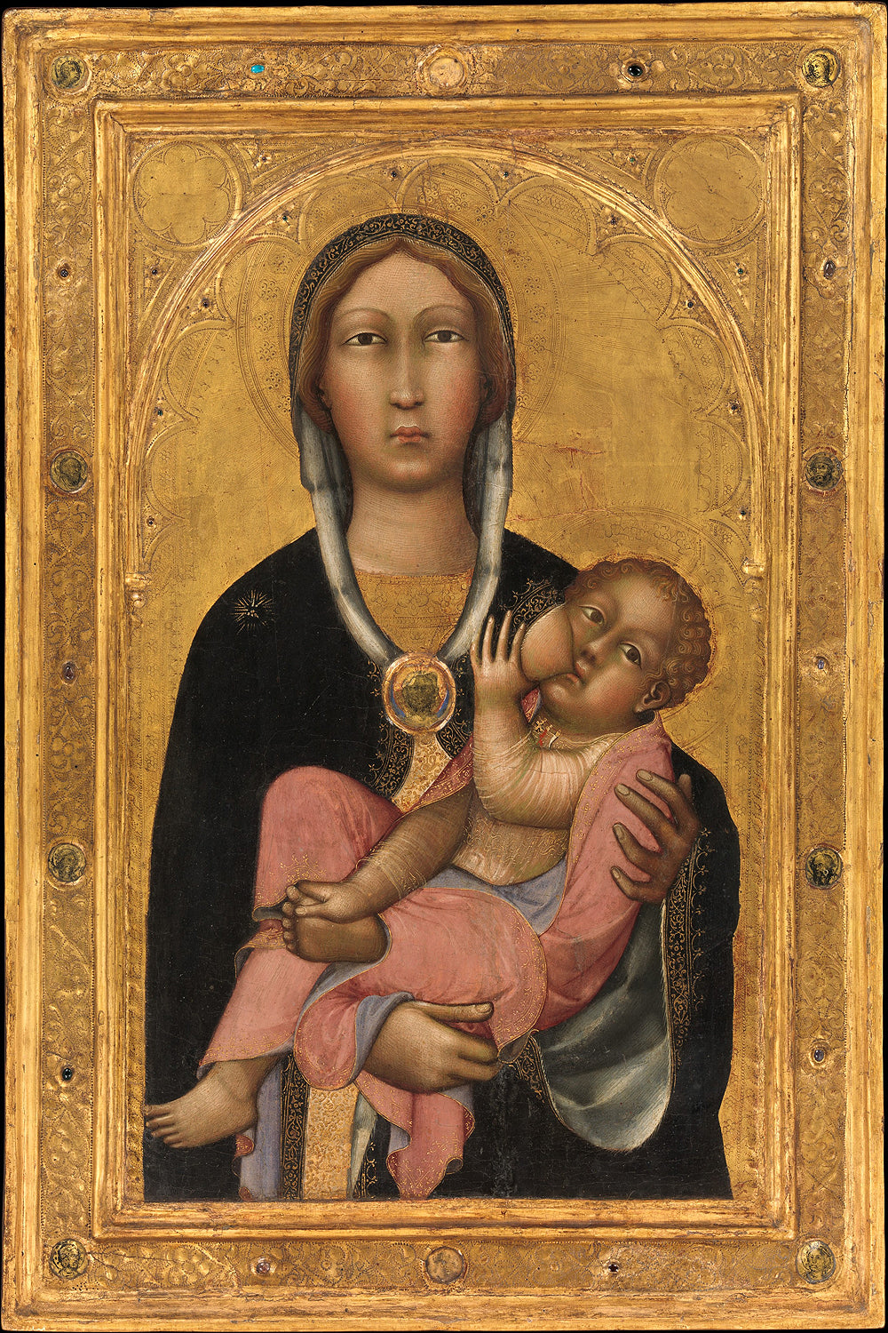 A printed artwork depicting the Madonna and Child, with the child resting in his mother's lap, set against a golden background, framed in a simple black frame.