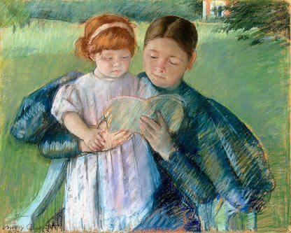 A framed print depicting two young girls, one holding a book, with a focus on soft, muted colors.