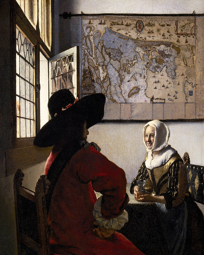 A framed print of Johannes Vermeer's painting 'Officer and Laughing Girl', featuring a man in a red coat and wide-brimmed hat conversing with a woman in a white dress, with a map in the background.