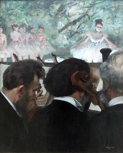 A framed print of 'Orchestra Musicians (1872)'' by Edgar Degas, depicting an indoor scene with a focus on the backs of several men in the foreground, with a blurred image of women on stage in the background.