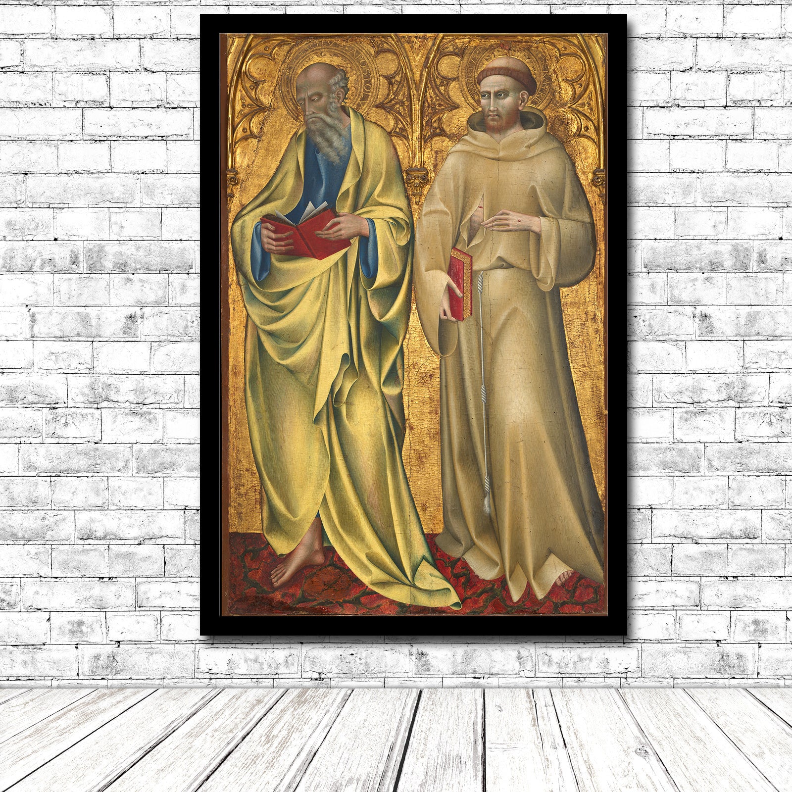 A printed artwork featuring two saints, Matthew and Francis, with a gold background and colorful robes, framed in a black frame.