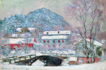 A framed print of a snowy landscape featuring a bridge, buildings, and trees covered in snow, with a solid black frame.