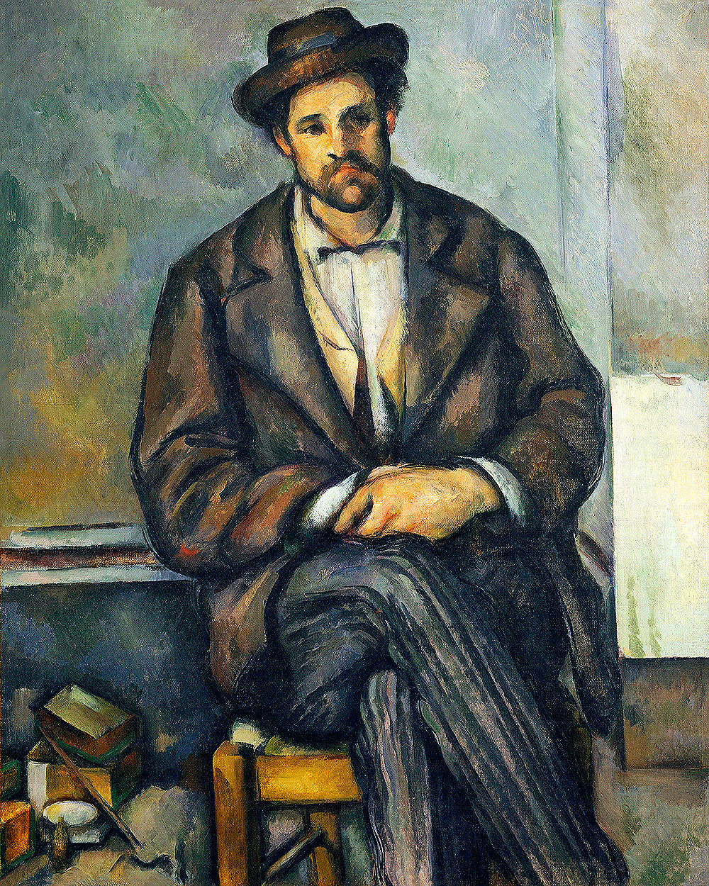 A framed print of 'Seated Peasant' by Paul Cezanne, depicting a man in a hat and coat sitting in a chair.