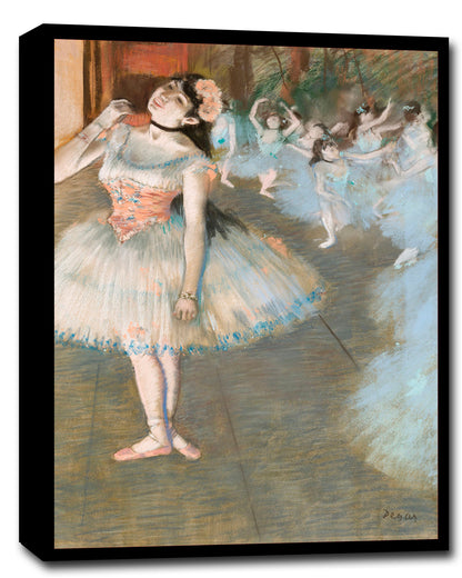 A framed print of a painting depicting ballerinas on stage, with a focus on a primary female figure in the foreground.