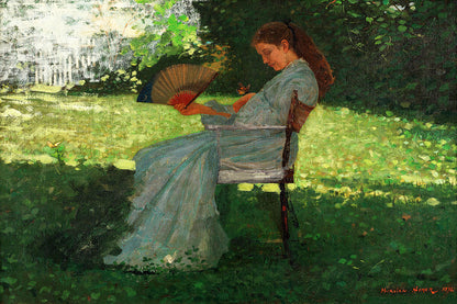 A printed art piece featuring a woman in a blue dress sitting on a bench, reading a book, with a decorative black frame around it.