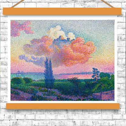 A framed print of a landscape painting featuring a prominent pink cloud in the sky, with green fields and trees in the foreground.