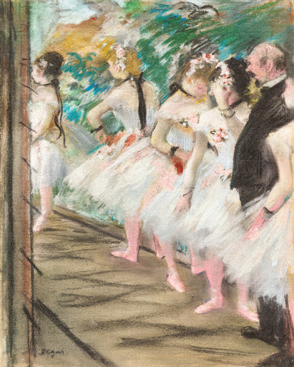 A framed print of 'The Ballet' by Edgar Degas, depicting ballerinas preparing on stage, with a black border and wooden frame.