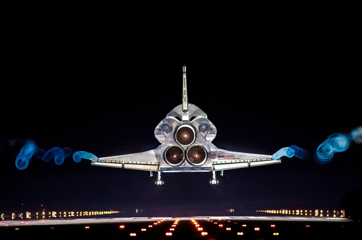 Vapor trails follow space shuttle Atlantis