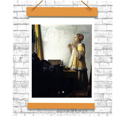 A printed reproduction of Johannes Vermeer's painting 'Young Woman with a Pearl Necklace', featuring a young woman in a baroque style dress, standing beside a window.