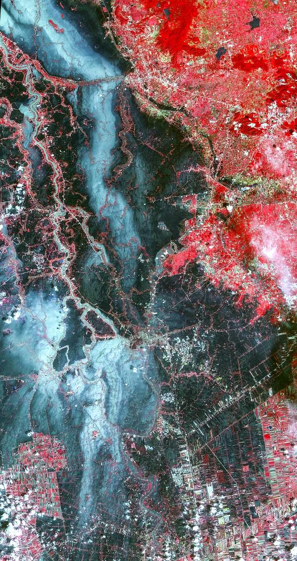 A satellite image of the Ayutthaya River in Bangkok with vibrant red and blue colors, representing different intensities or features on the Earth's surface.