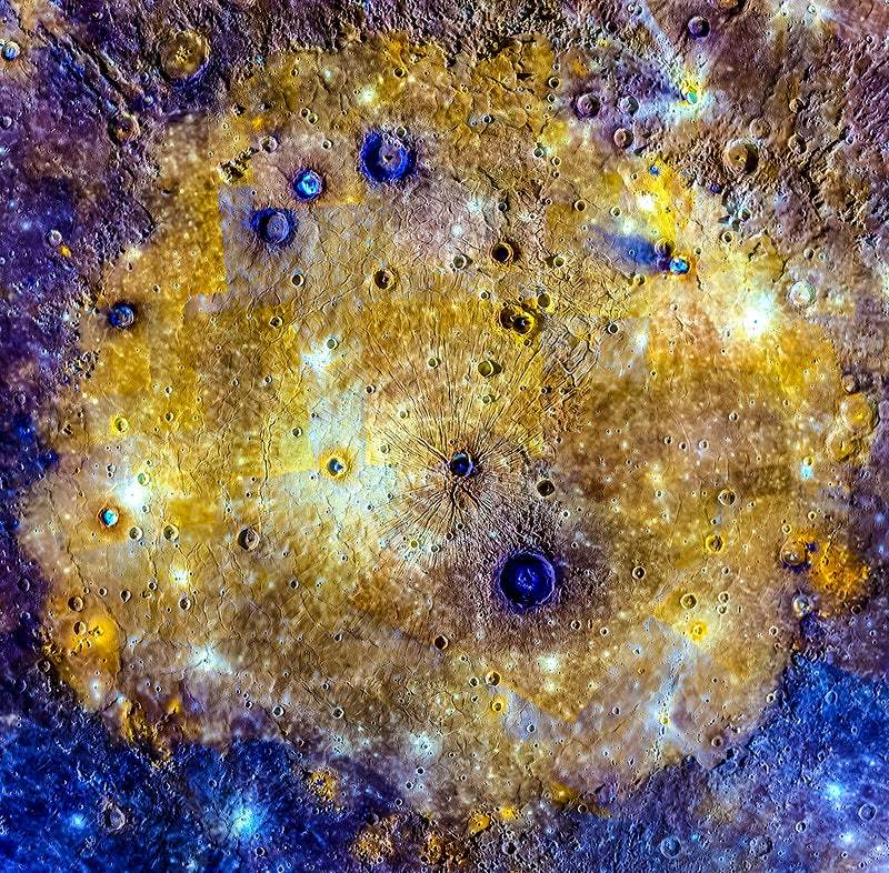 A vibrant image of a celestial body, possibly a moon, with a detailed and textured surface featuring craters and shades of yellow, gold, purple, and blue.