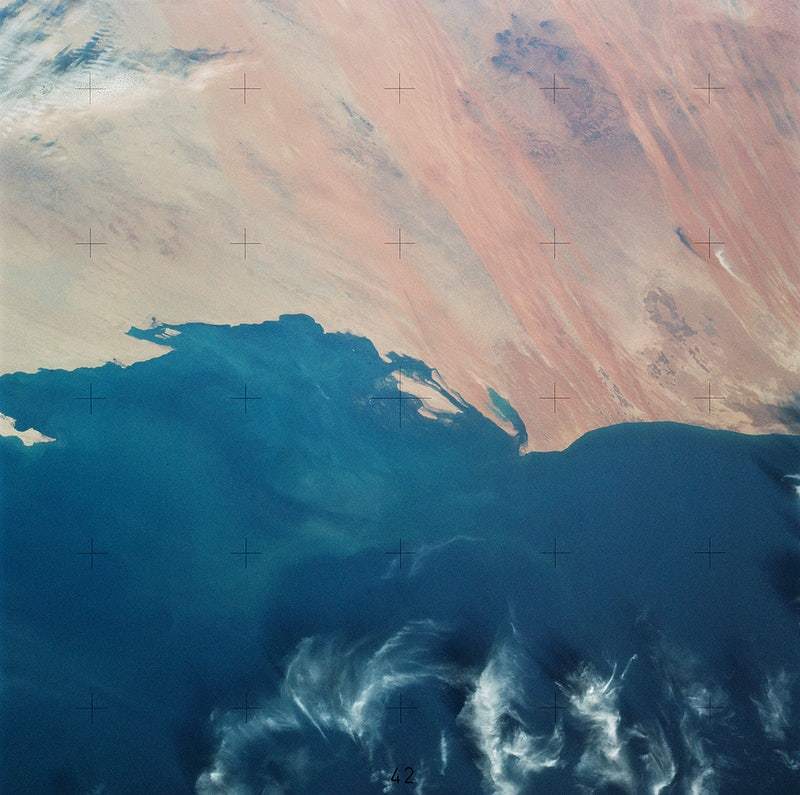 A satellite image of Mauritania's Atlantic Coast featuring hues of blue and orange, representing the sea and land respectively, with visible coastlines and water patterns.