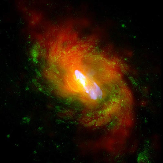 A colorful image of a galaxy, featuring shades of orange, green, and red, representing a deep space photo by NASA.