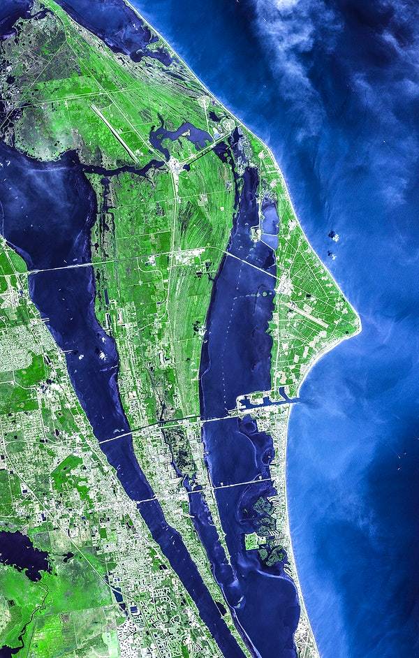A satellite view of the John F. Kennedy Space Center, with greenery and water visible.