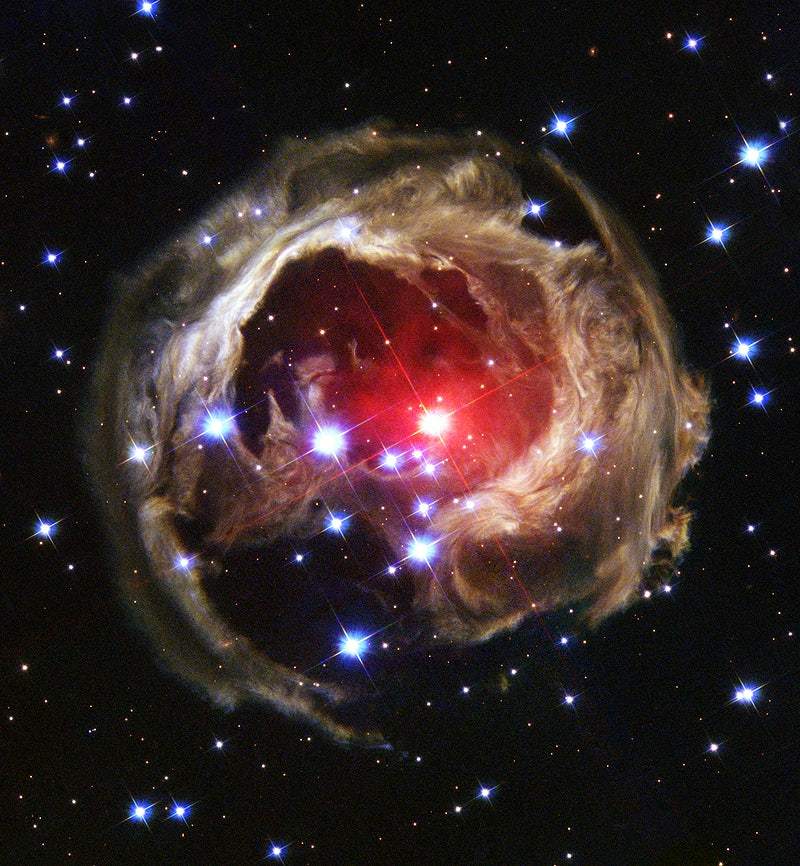 A space-related photograph featuring celestial bodies and a starry background, likely representing a deep space exploration image.